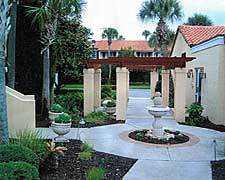 Walkway with shrubs and fountain