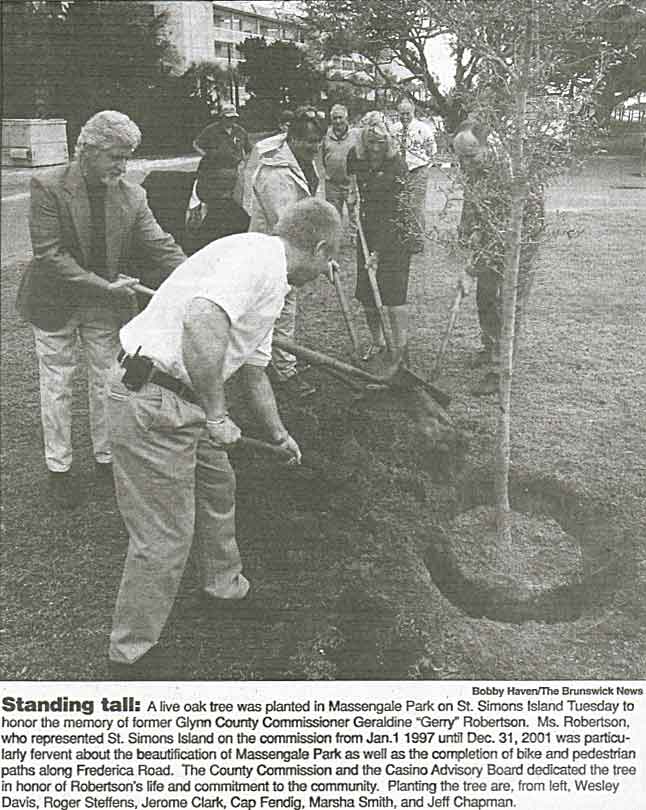 Roger Steffens helps plant live oak in Massengale Park memorial